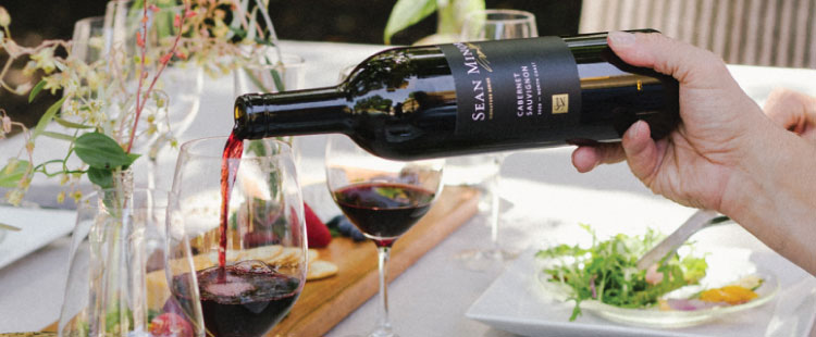 red wine being poured in to a wine glass