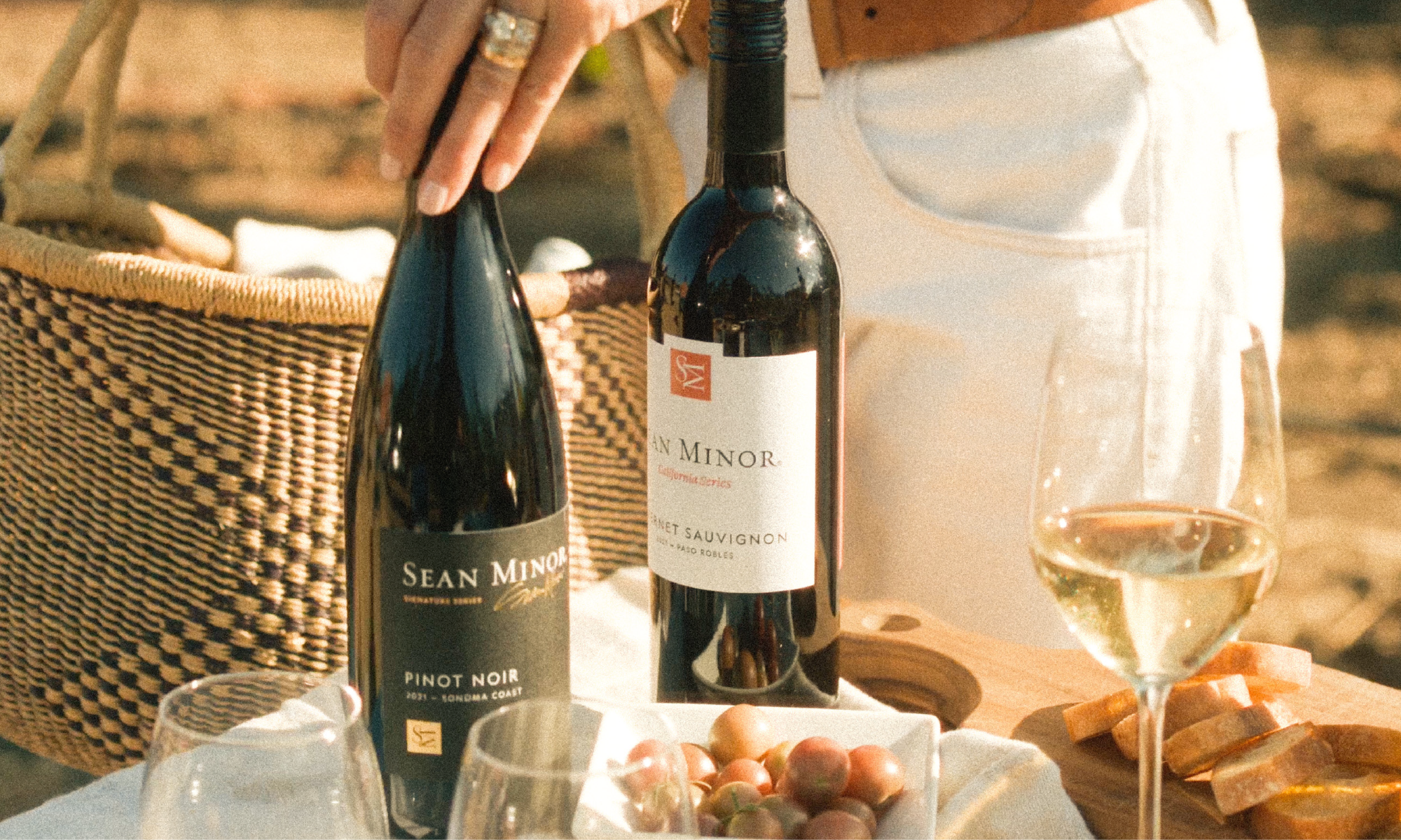 two bottles of wione on a tables scape a pinot noir and cabernet sauvignon