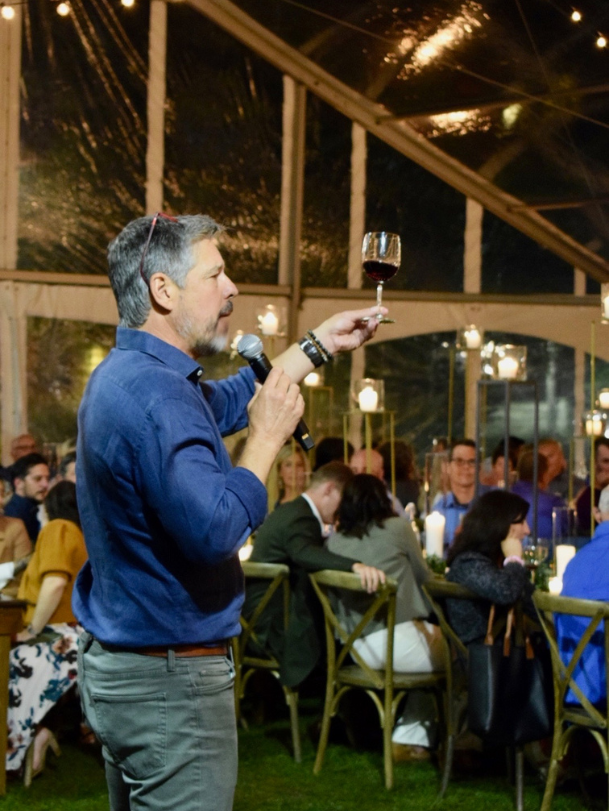 Sean holding up a glass as he does a tasting