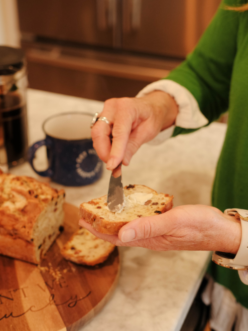 spreading butter on irish soda bread