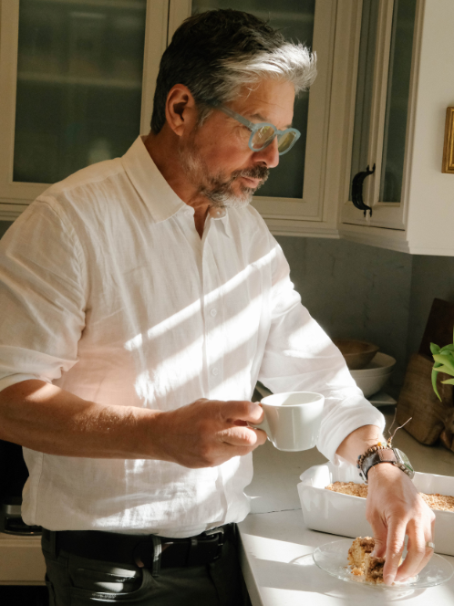 sean with cup of coffee and coffee cake