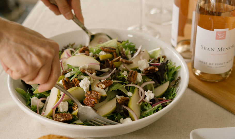 bowl of baby greens salad with goat cheese and pecans