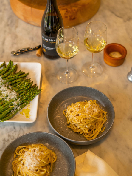 plate of cacio e pepe with wine