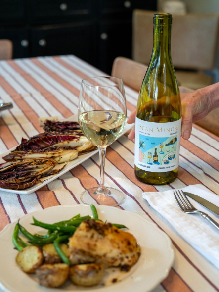 fennel chicken plate with glass of invited series sauvignon blanc bottle of wine