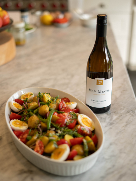 Platter of potato salad and bottle of chardonnay