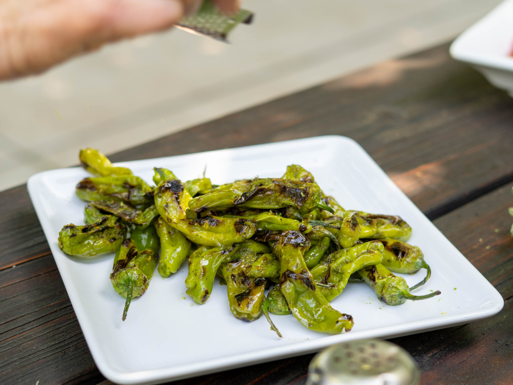 platter of grilled shishito peppers