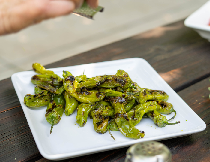 platter of grilled shishito peppers