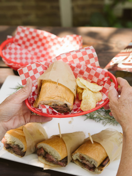 basket with steak sandwich and potato chips