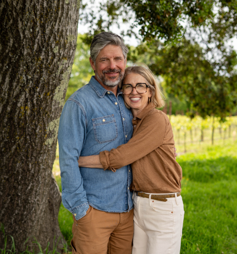 sean and nicole hugging vineyards