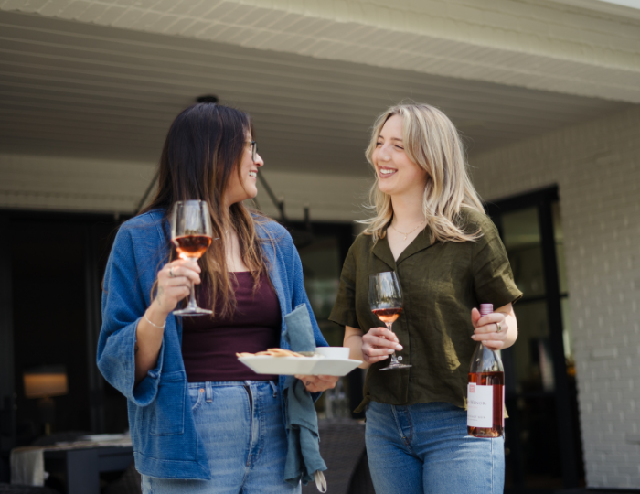 two ladies holding glasses of rose