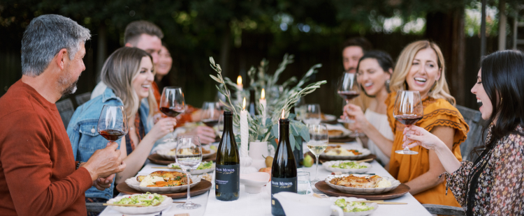 people enjoying wine at a table