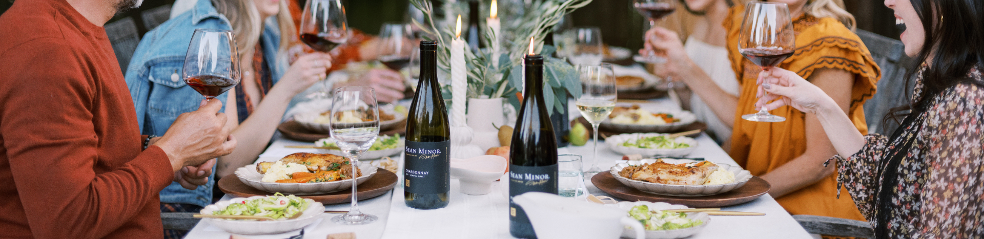 two bottles of wine at a dinner table